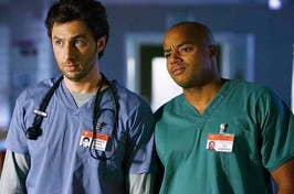 Two doctors from TV show 'Scrubs' in scrubs looking concerned