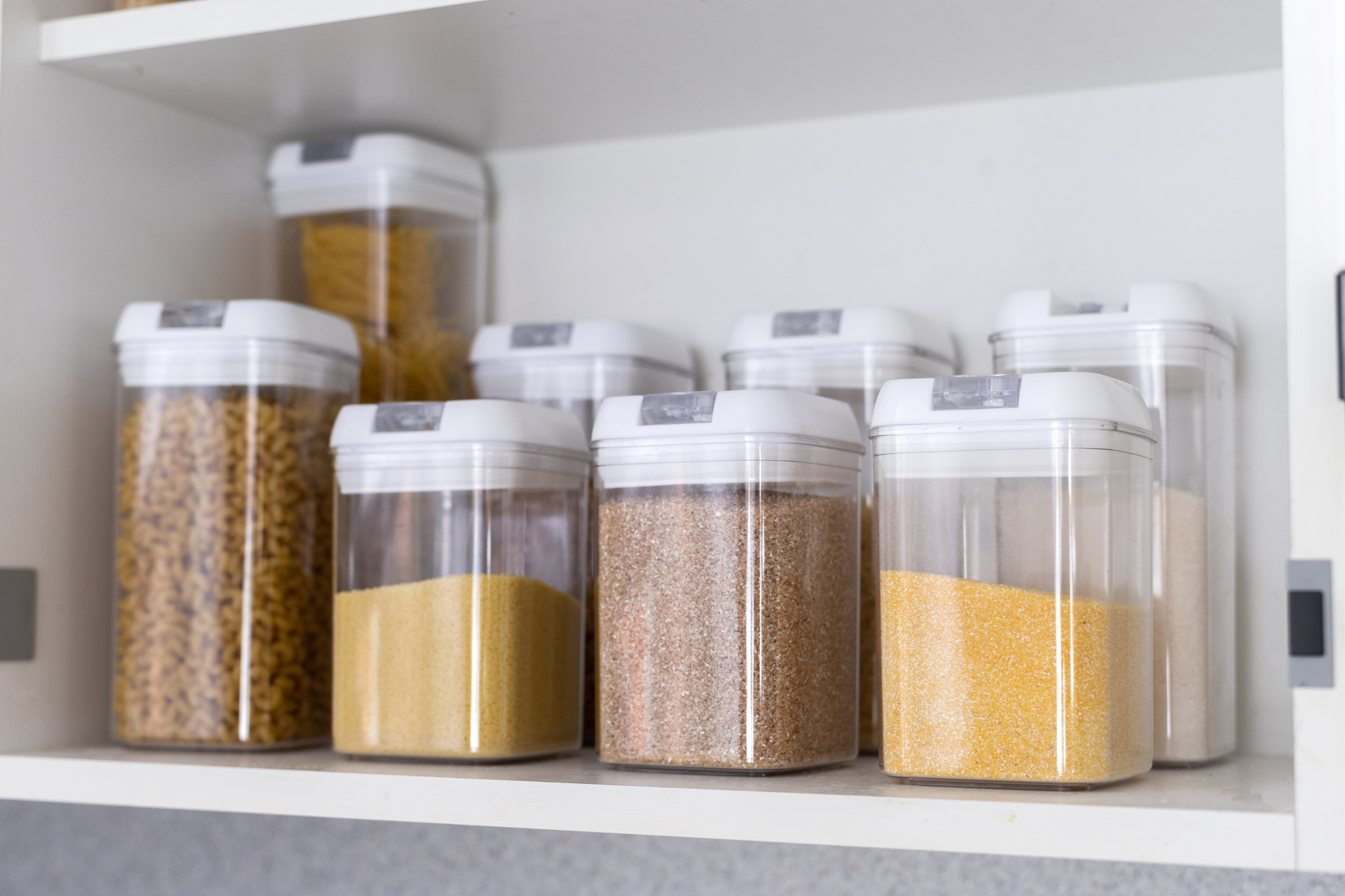 matching canisters of ingredients on a pantry shelf