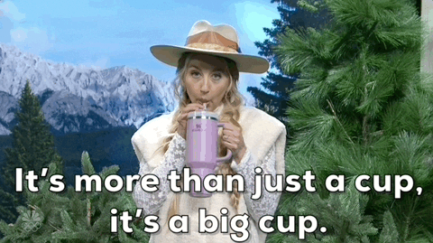 Person sipping from a large cup with text &quot;It&#x27;s more than just a cup, it&#x27;s a big cup.&quot;
