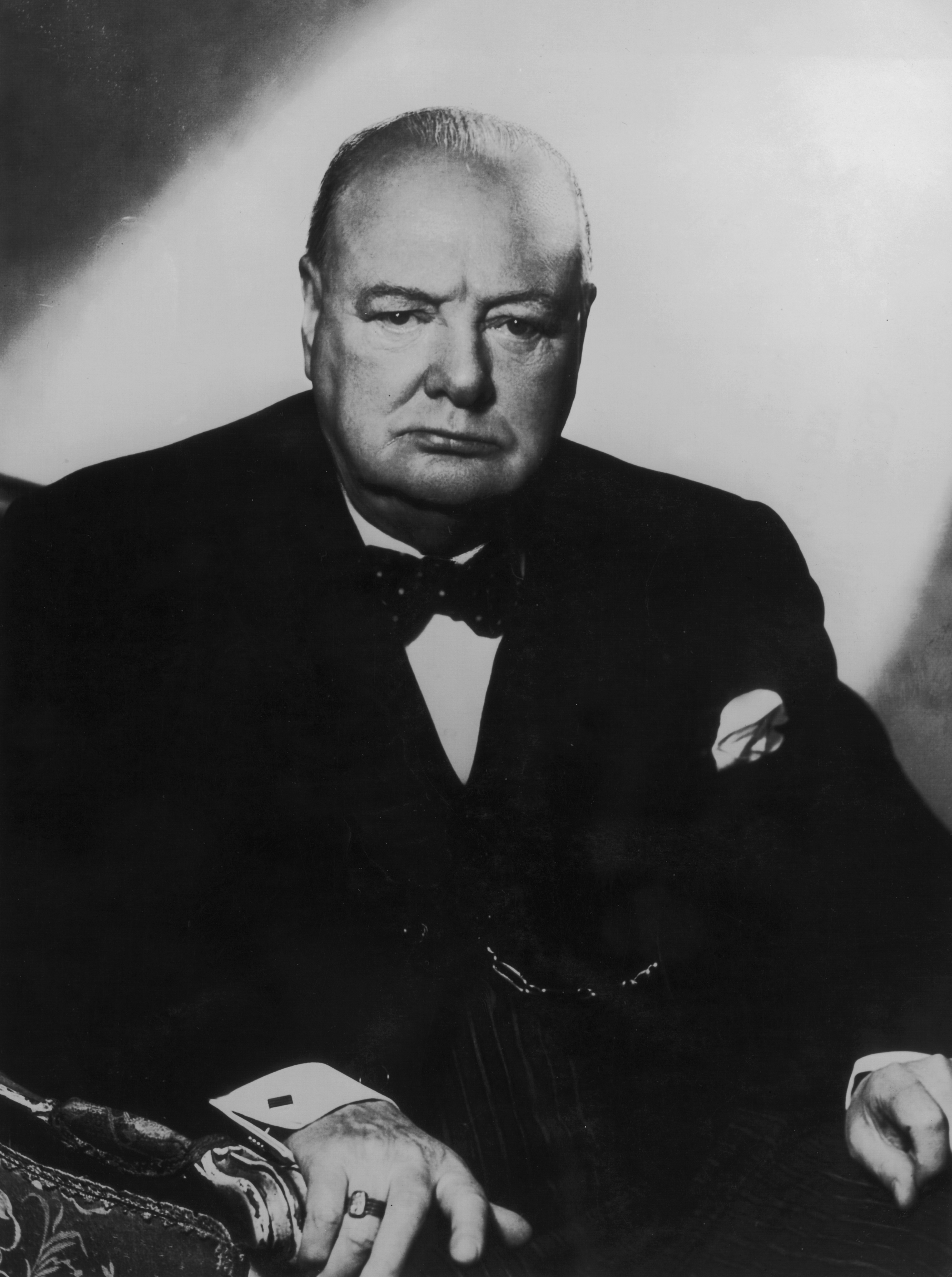Portrait of Winston Churchill in a formal suit with a bow tie and pocket square