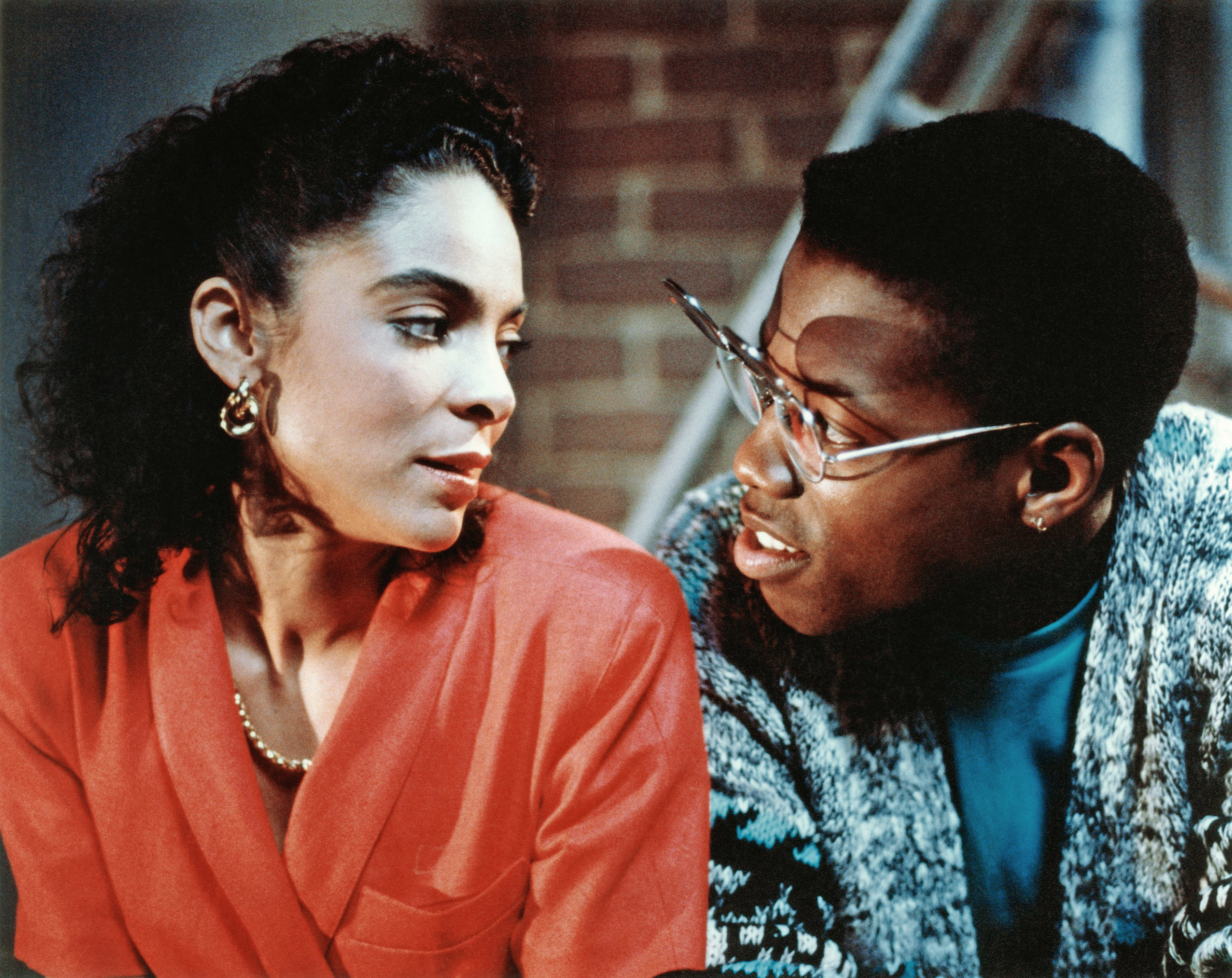 Two characters from &quot;Coming to America&quot; are engaged in conversation