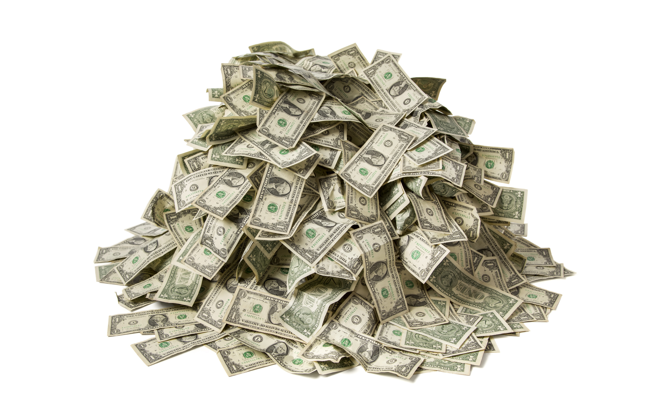 Pile of US one-dollar bills scattered on a plain background