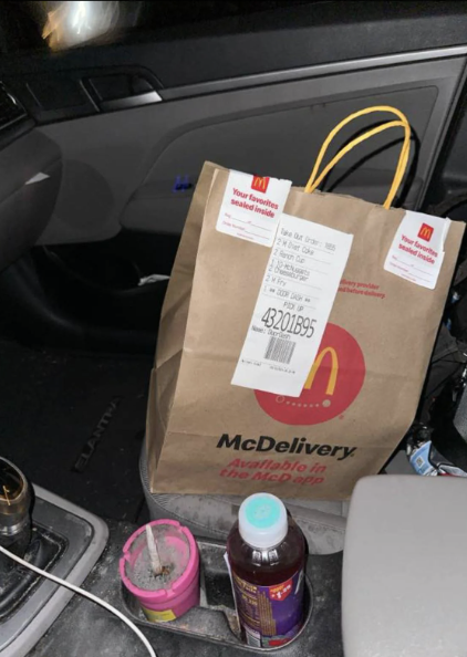 McDonald&#x27;s delivery bag with a long receipt attached inside a car