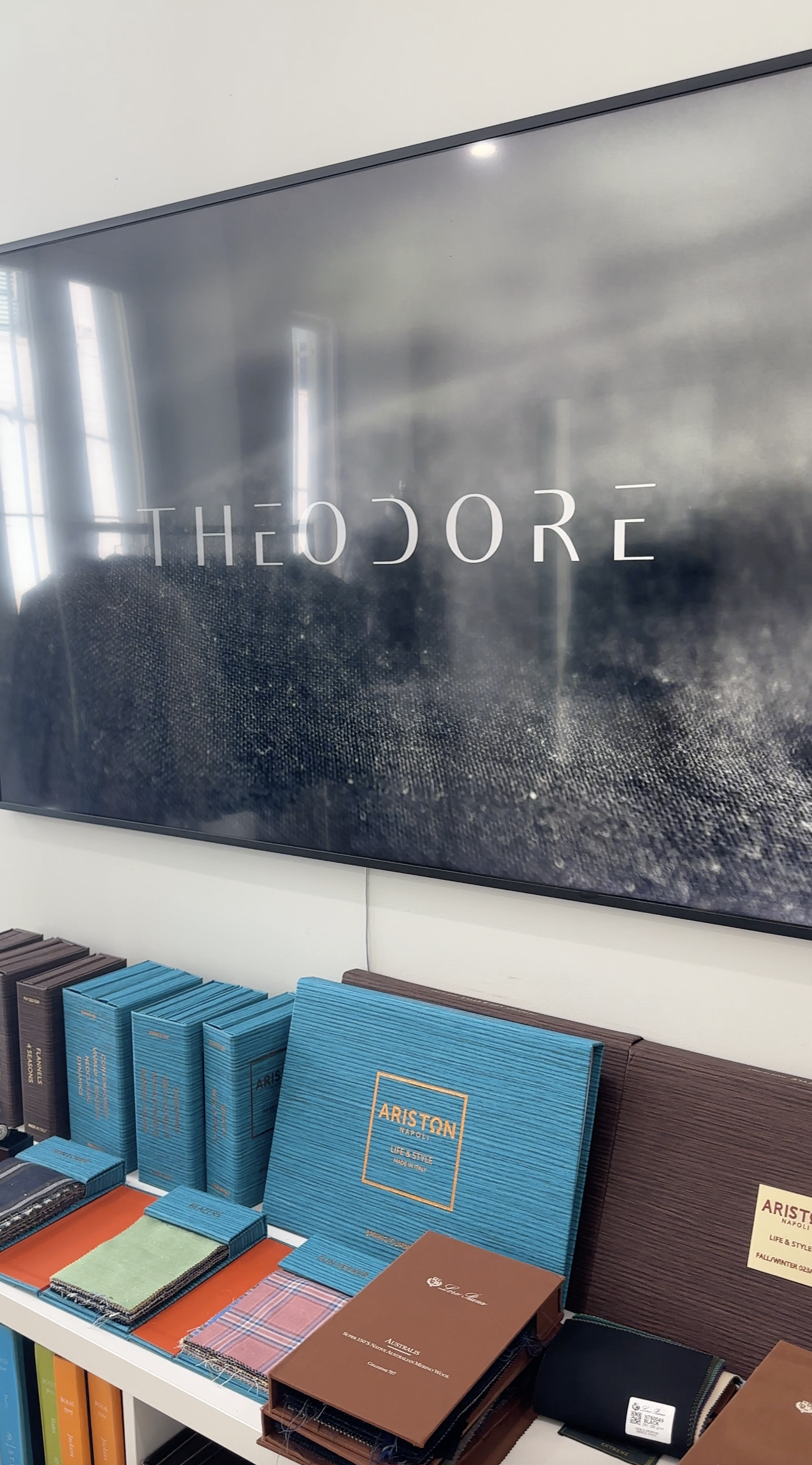 Sign reading &quot;THEODORE&quot; above shelves with various hardcover books