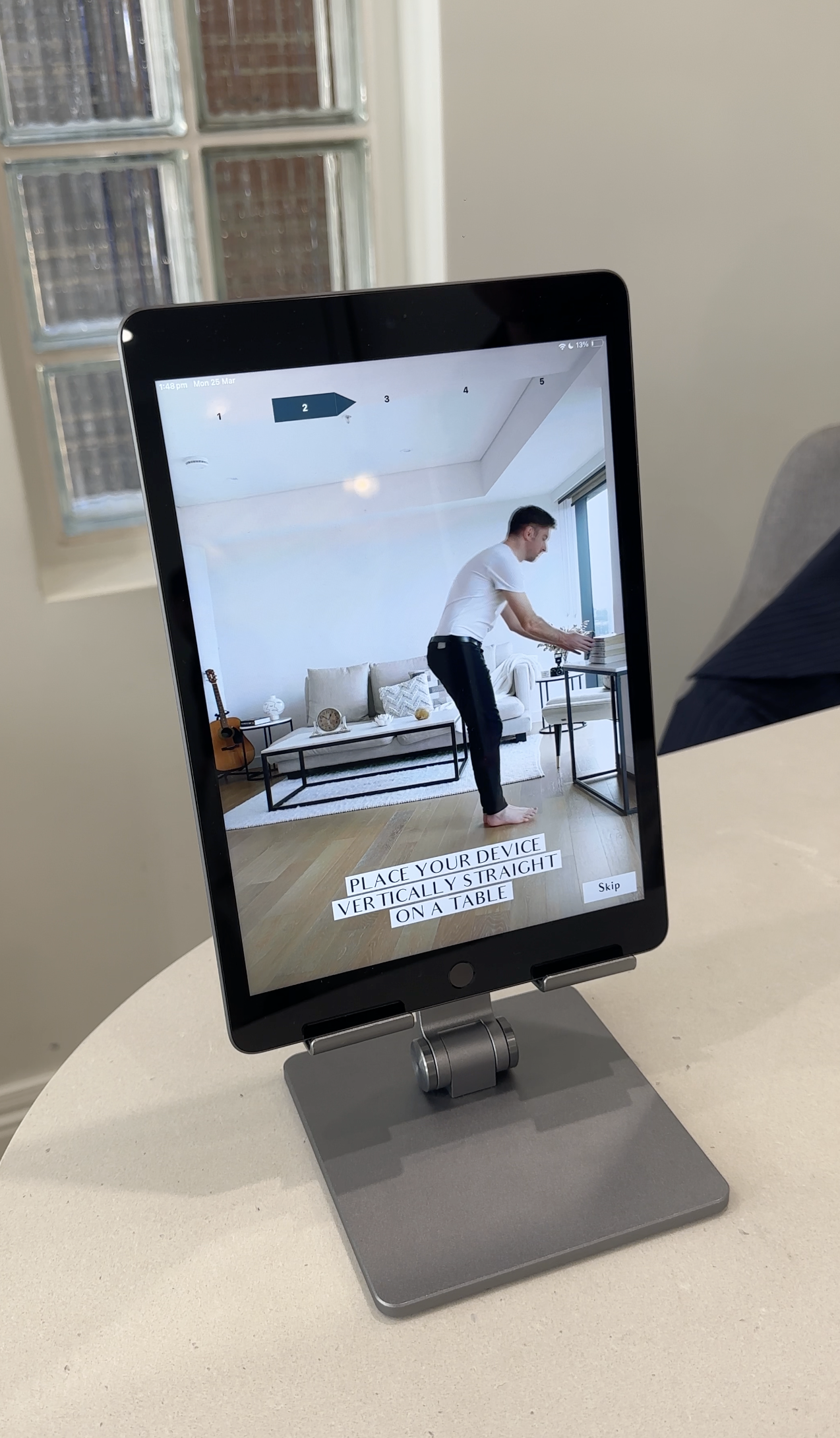 A man on a digital device screen performing a step as part of a virtual setup process, with an instruction overlay