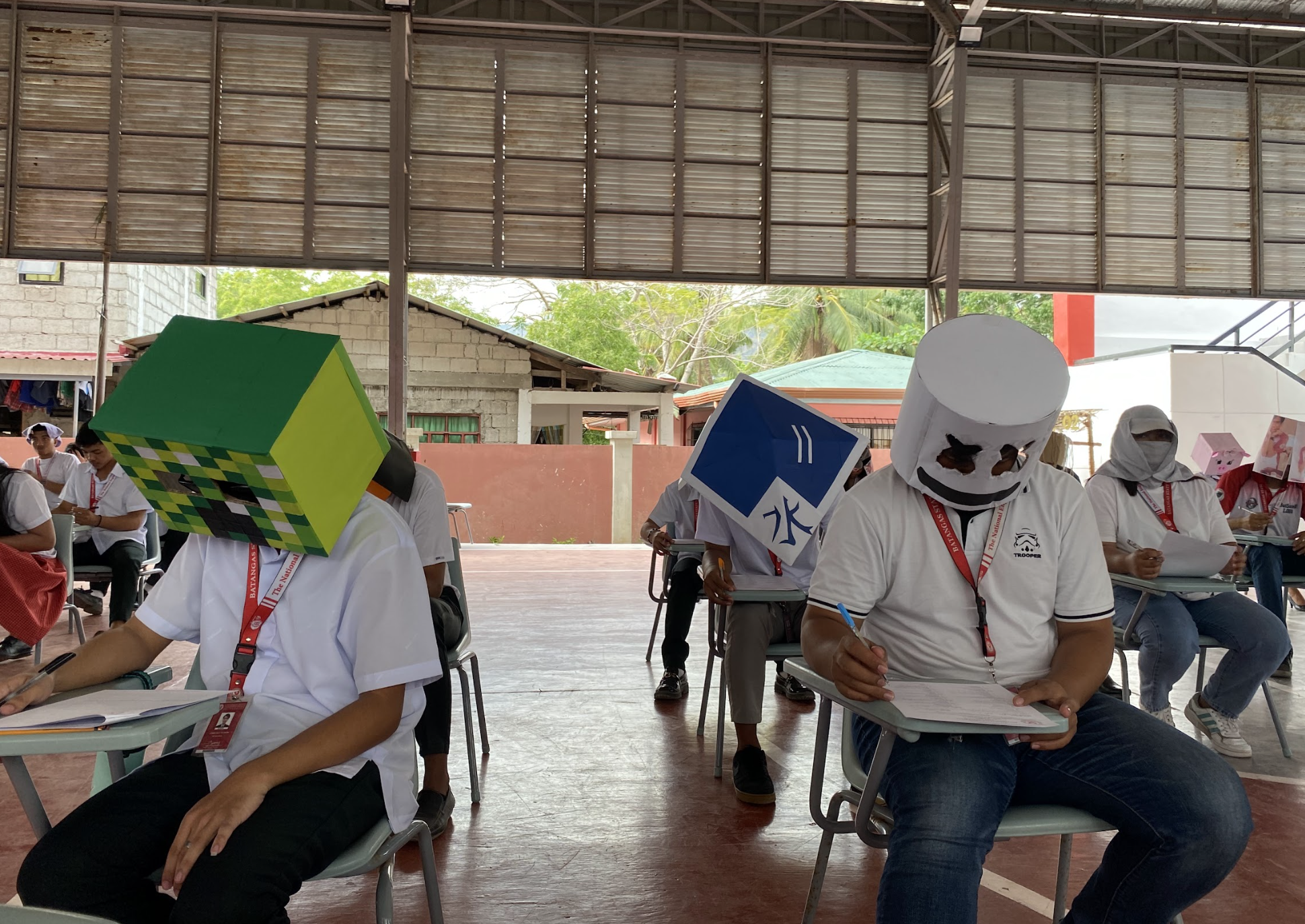 Students wearing cube and round masks at desks