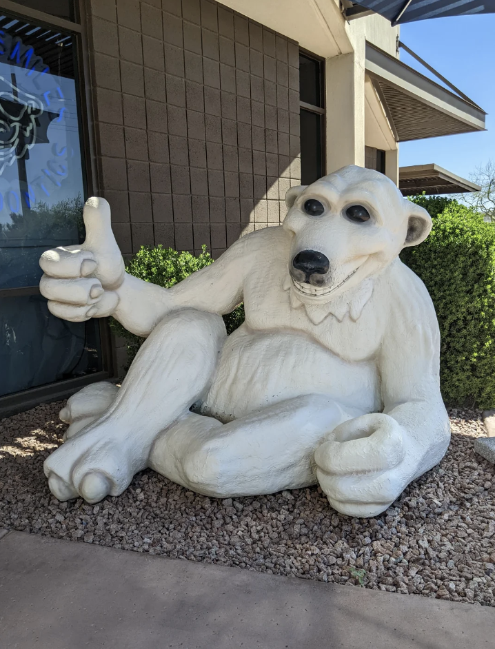 Large sculpture of a cartoonish bear giving a thumbs-up