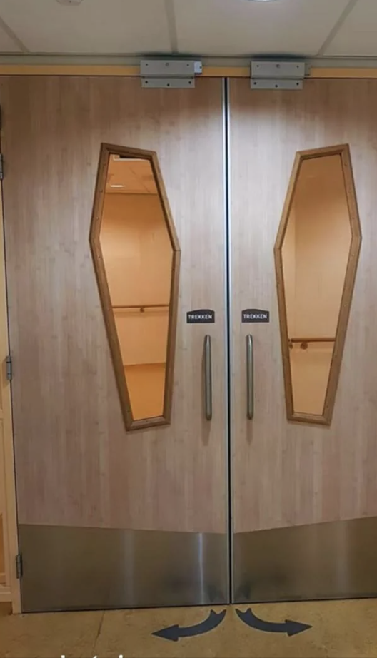 Elevator doors with coffin-shaped windows reflecting the Internet&#x27;s interest in quirky designs
