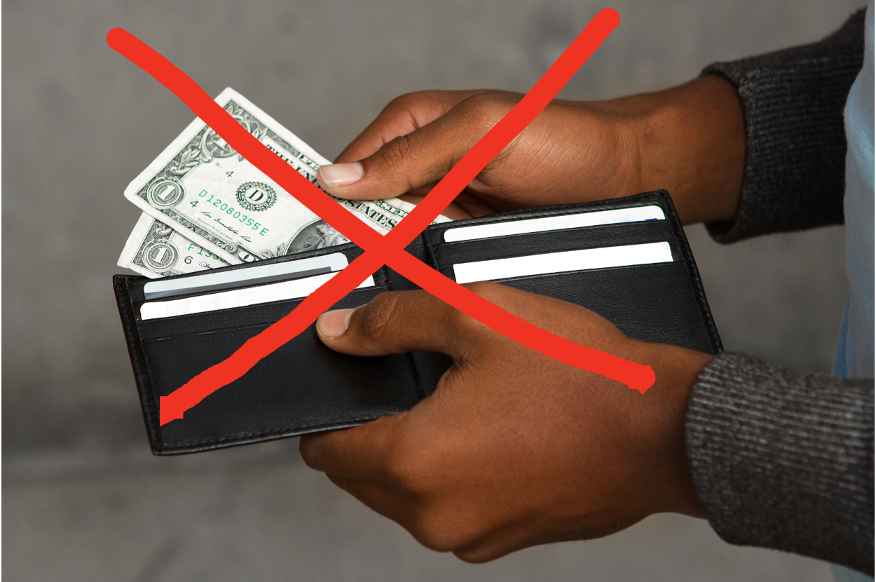 Person holding a wallet with a small amount of cash, concept for limited funds or budgeting