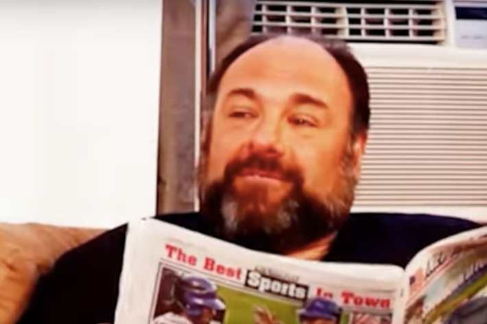 Gandolfini reading a newspaper titled "The Best Sports in Town"