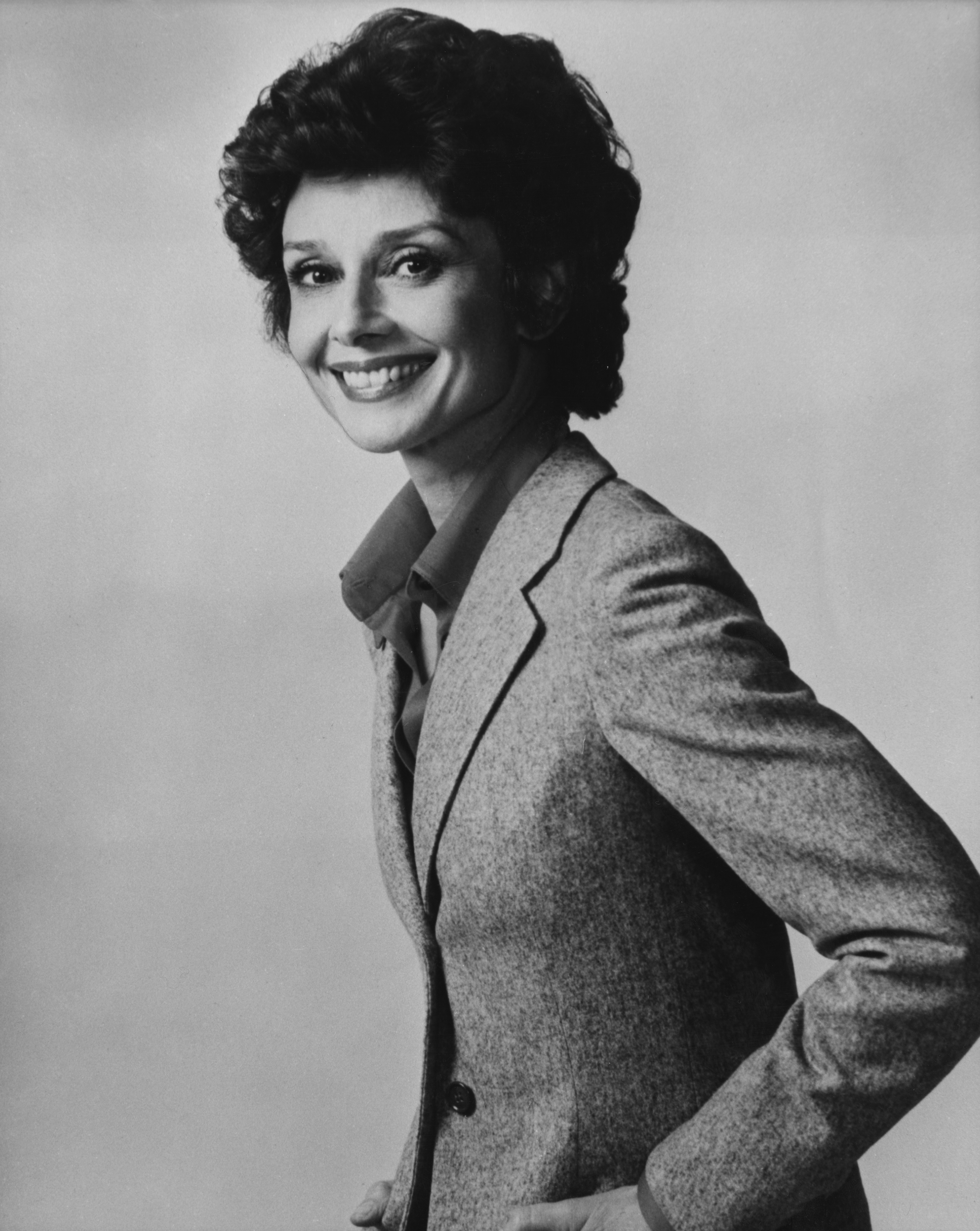 Annette Funicello poses in a classic blazer and blouse with a confident smile