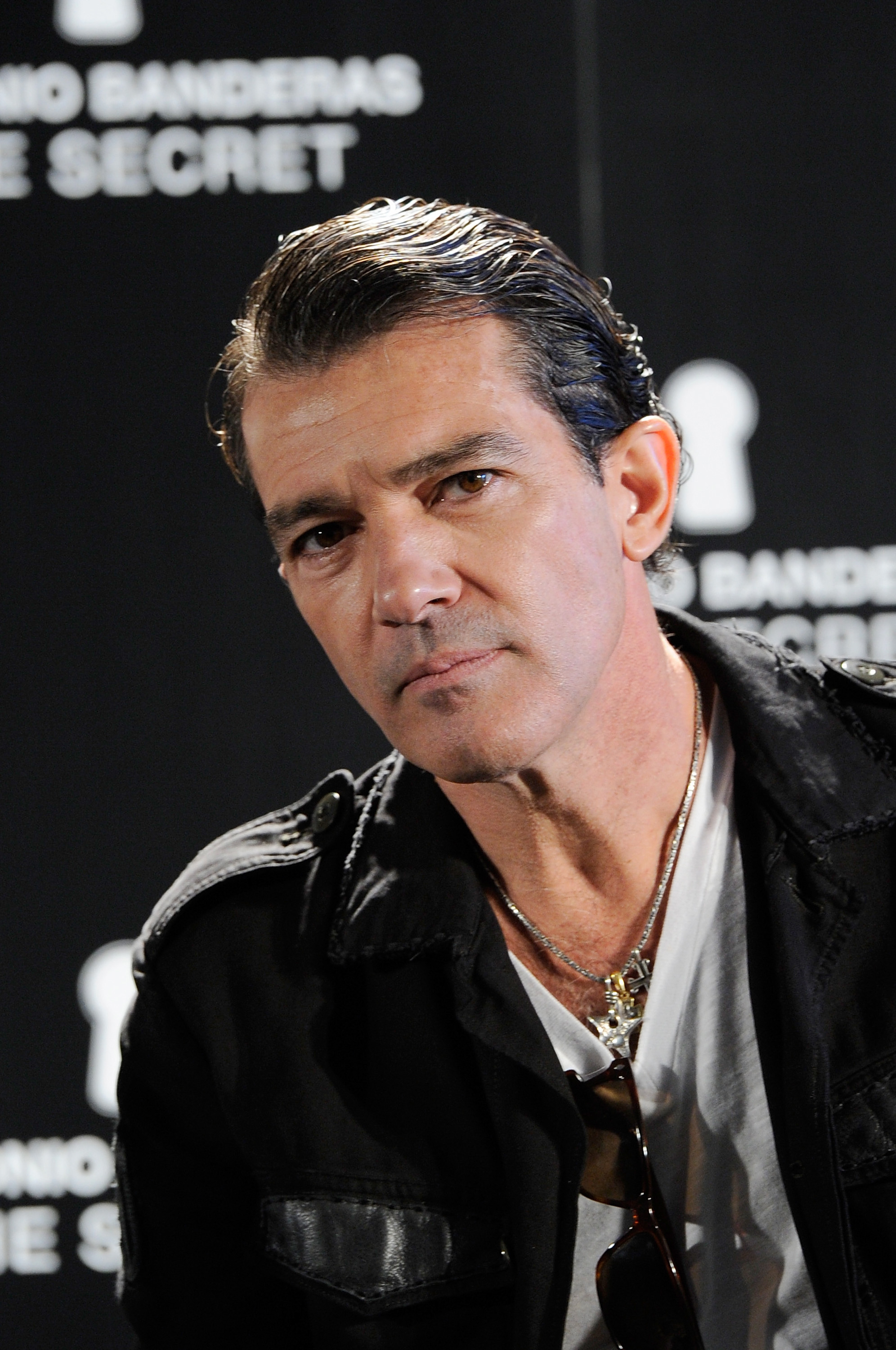Antonio Banderas in leather jacket over a shirt, at a promotional event