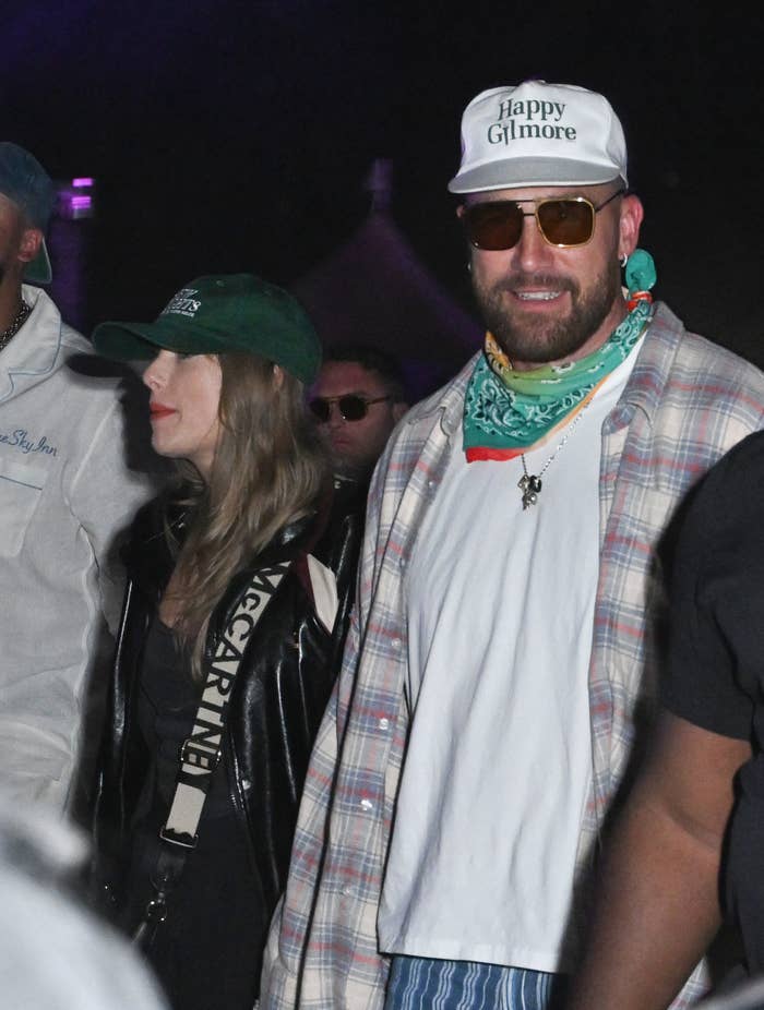 Closeup of Taylor Swift and Travis Kelce at Coachella. They&#x27;re both wearing somewhat casual clothes and baseball caps