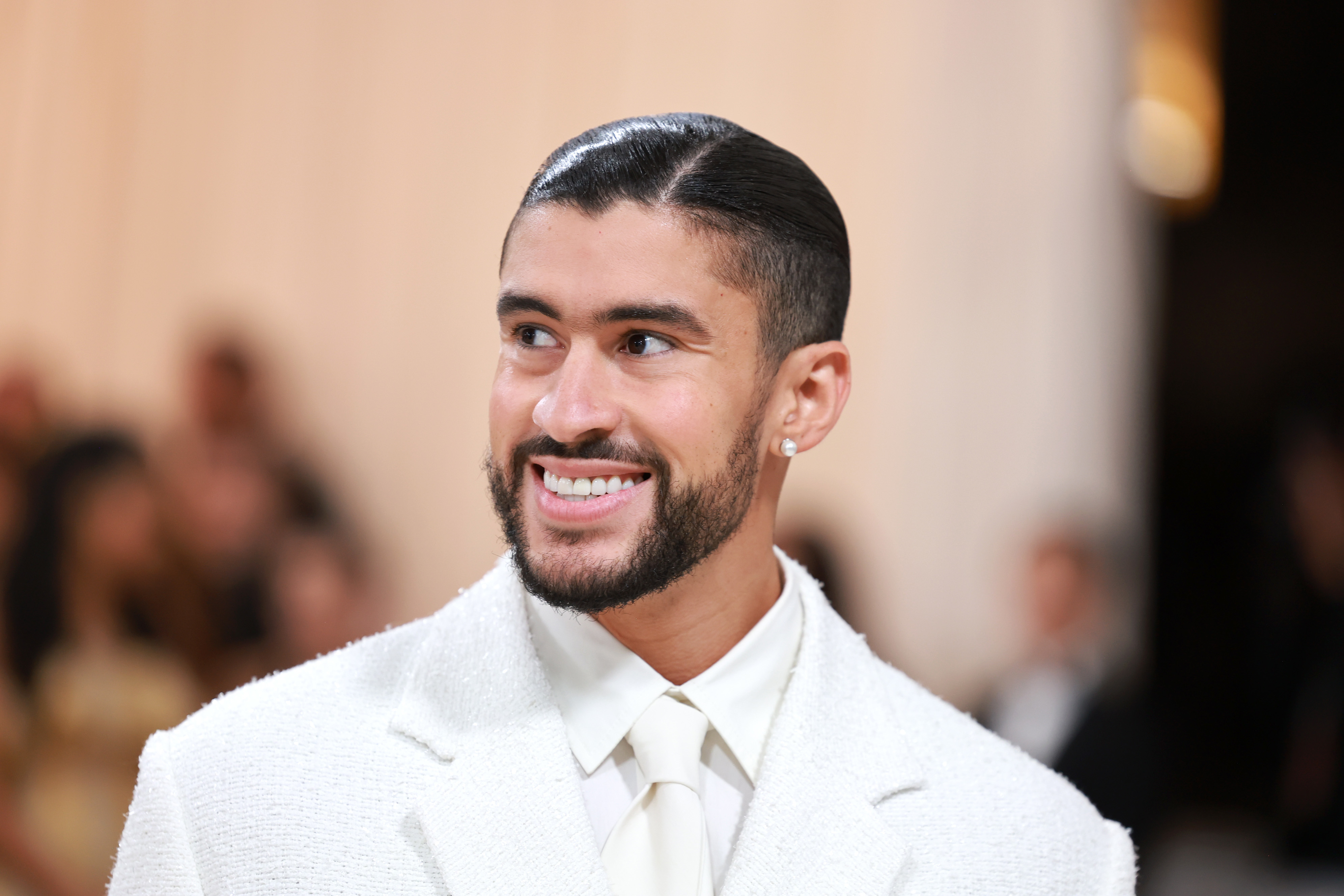 Closeup of Bad Bunny smiling on the Met Gala red carpet
