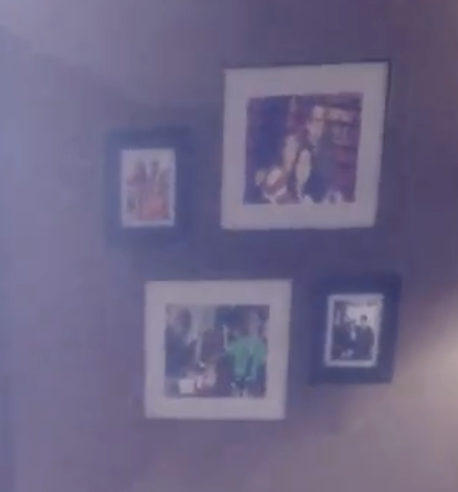 A wall displaying a collection of four variously sized and framed photographs
