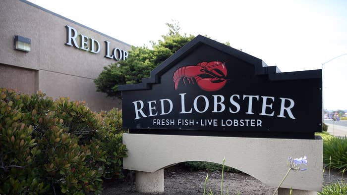 Red Lobster restaurant sign featuring a lobster graphic and text: &quot;Fresh Fish - Live Lobster.&quot;