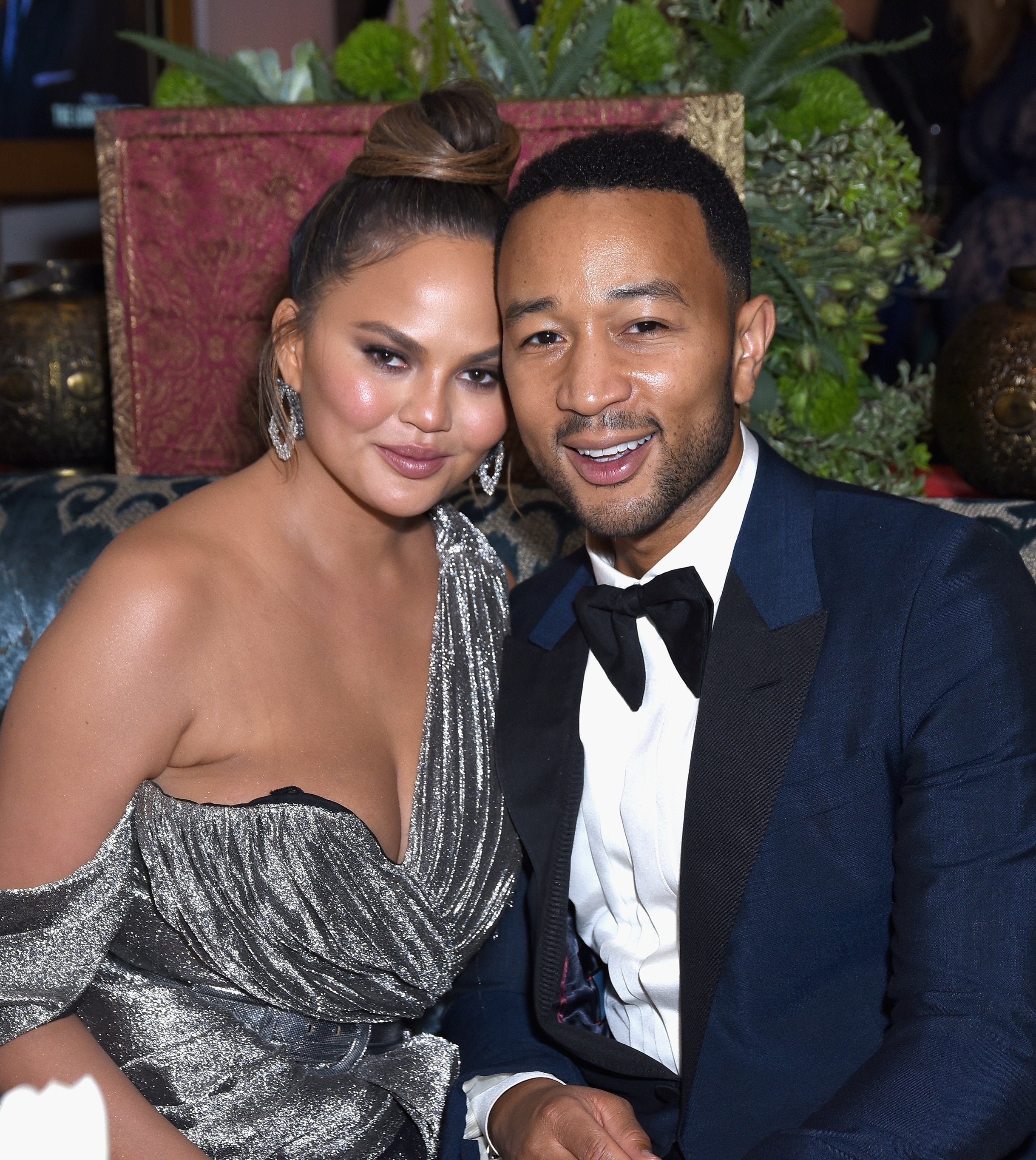 Closeup of Chrissy Teigen and John Legend leaning into each other for a photo