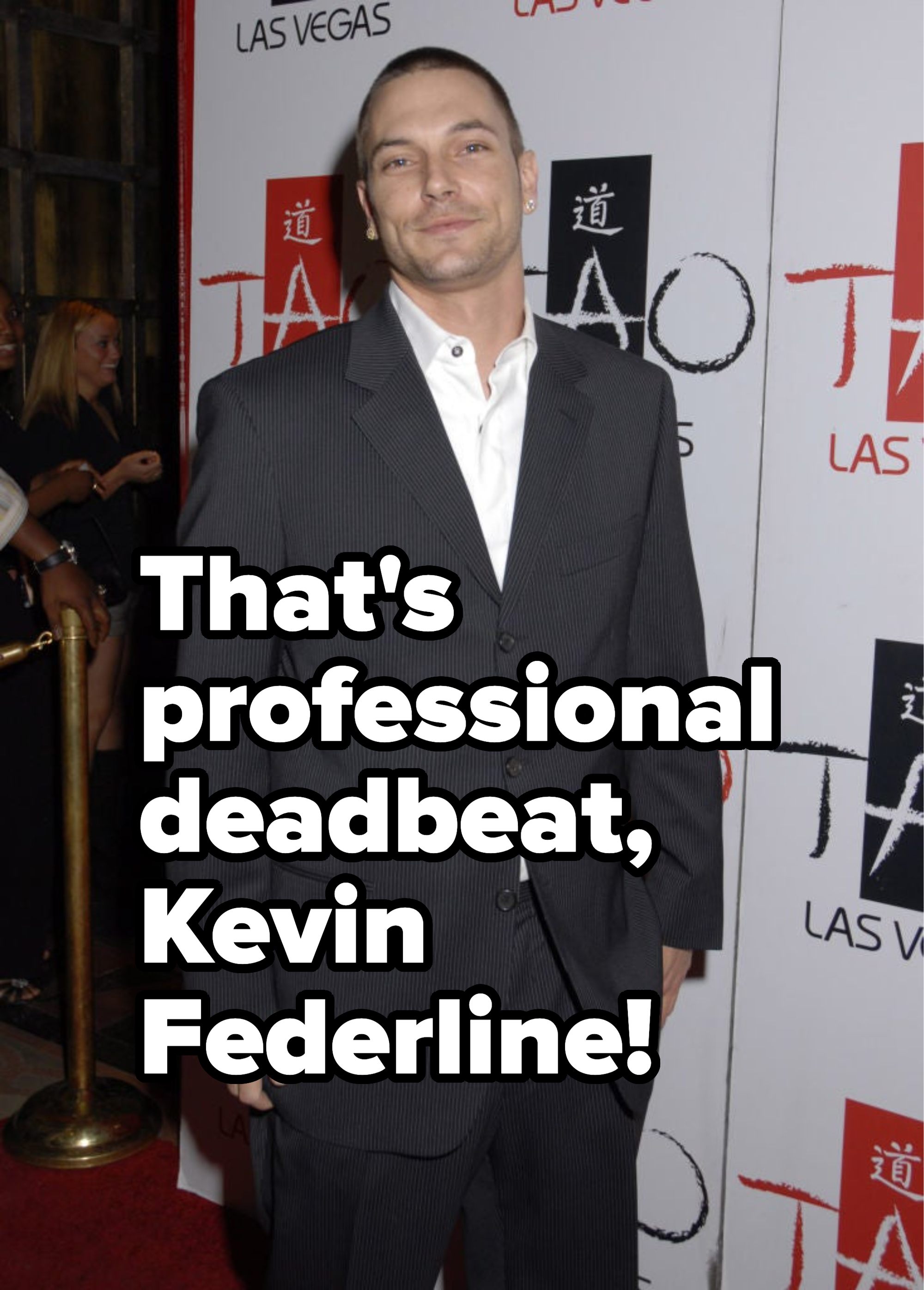 Kevin Federline in a pinstripe suit and white shirt on a red carpet