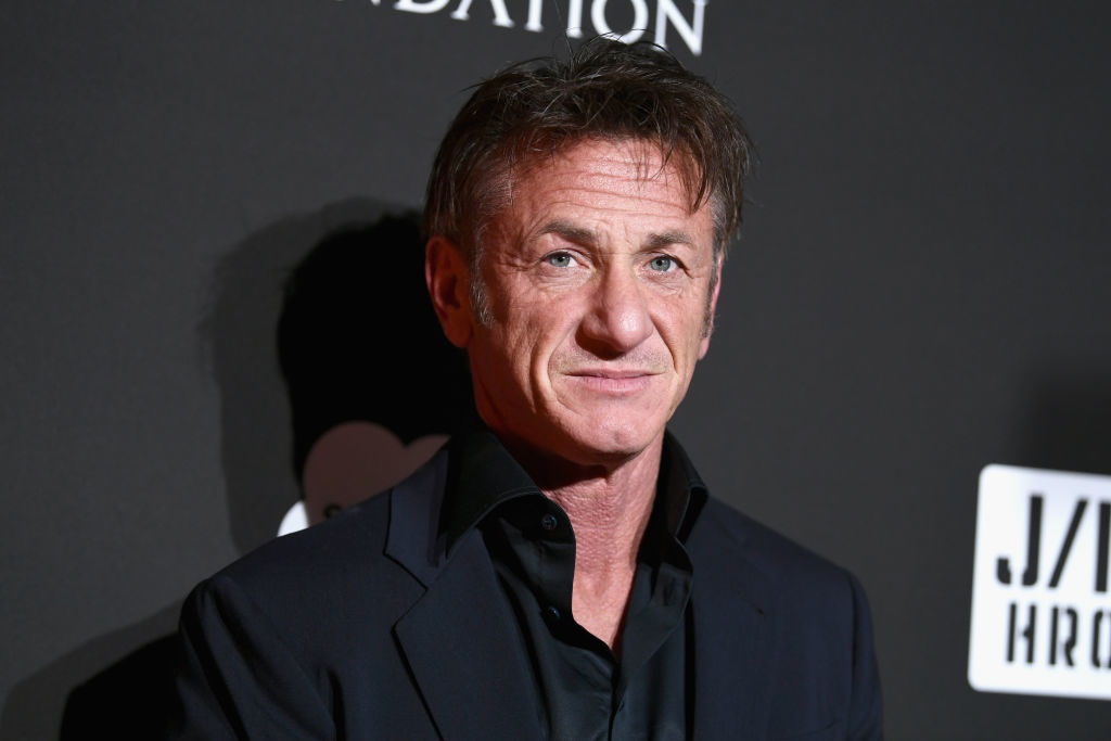Sean Penn in a black suit and tie at an event
