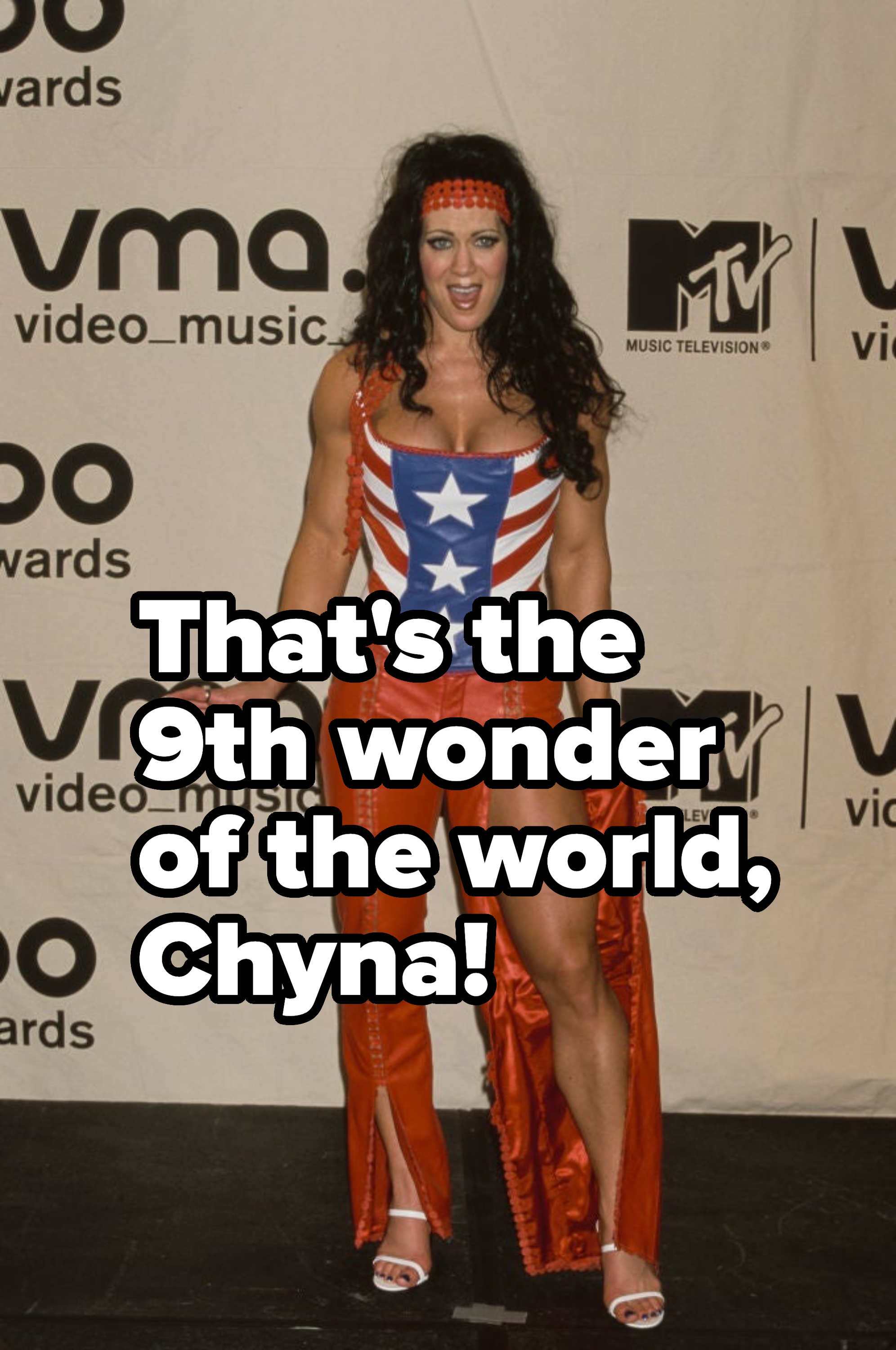 Woman in American flag-inspired outfit with headdress at an awards event