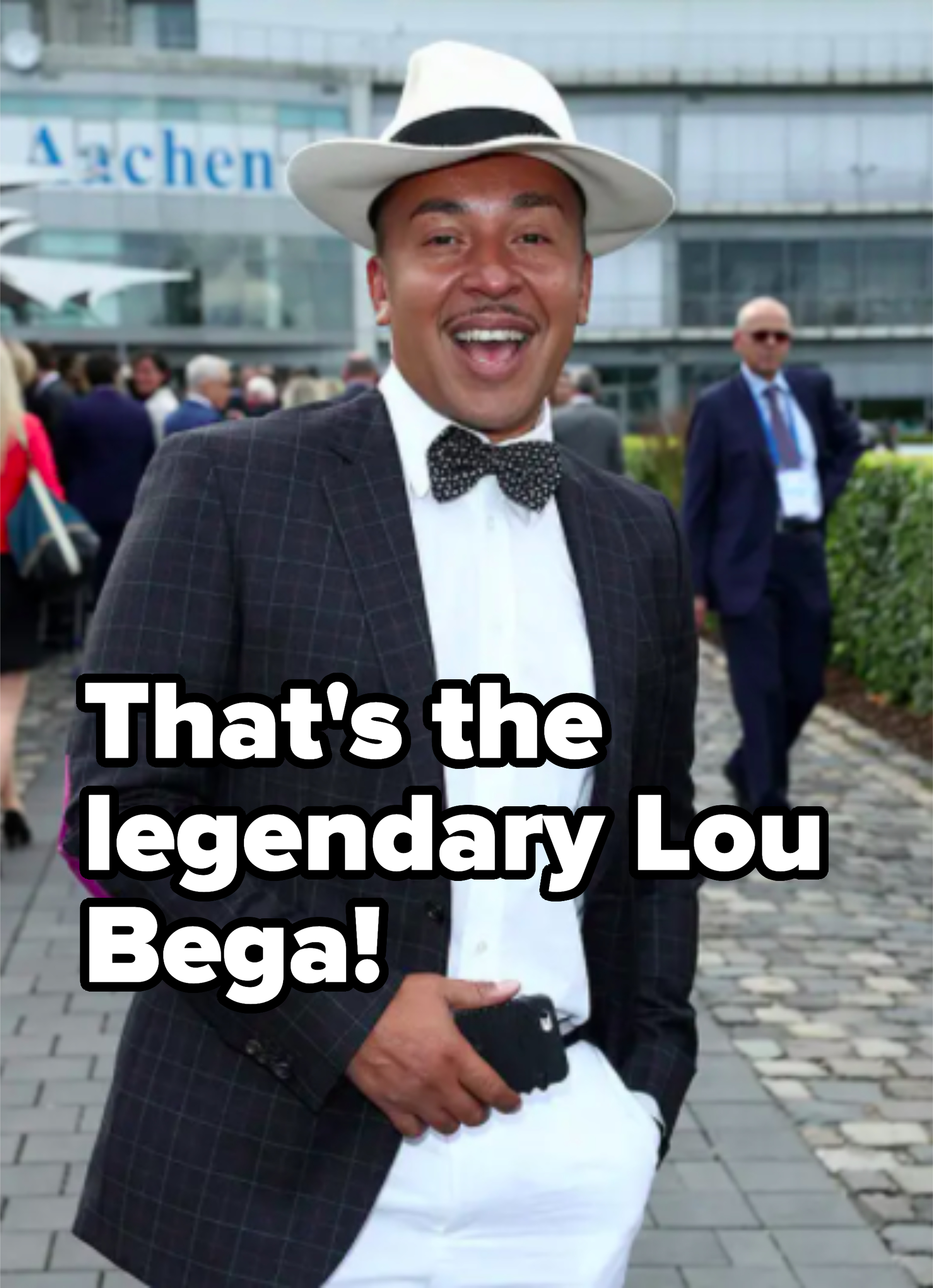 he's wearing a fedora at some sort of horse race