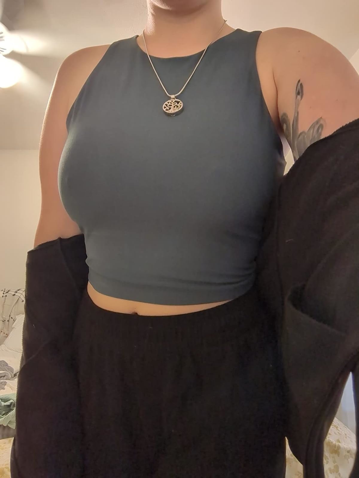 Reviewer's photograph  of them wearing a grey cropped vessel  apical  and achromatic  high-waisted pants
