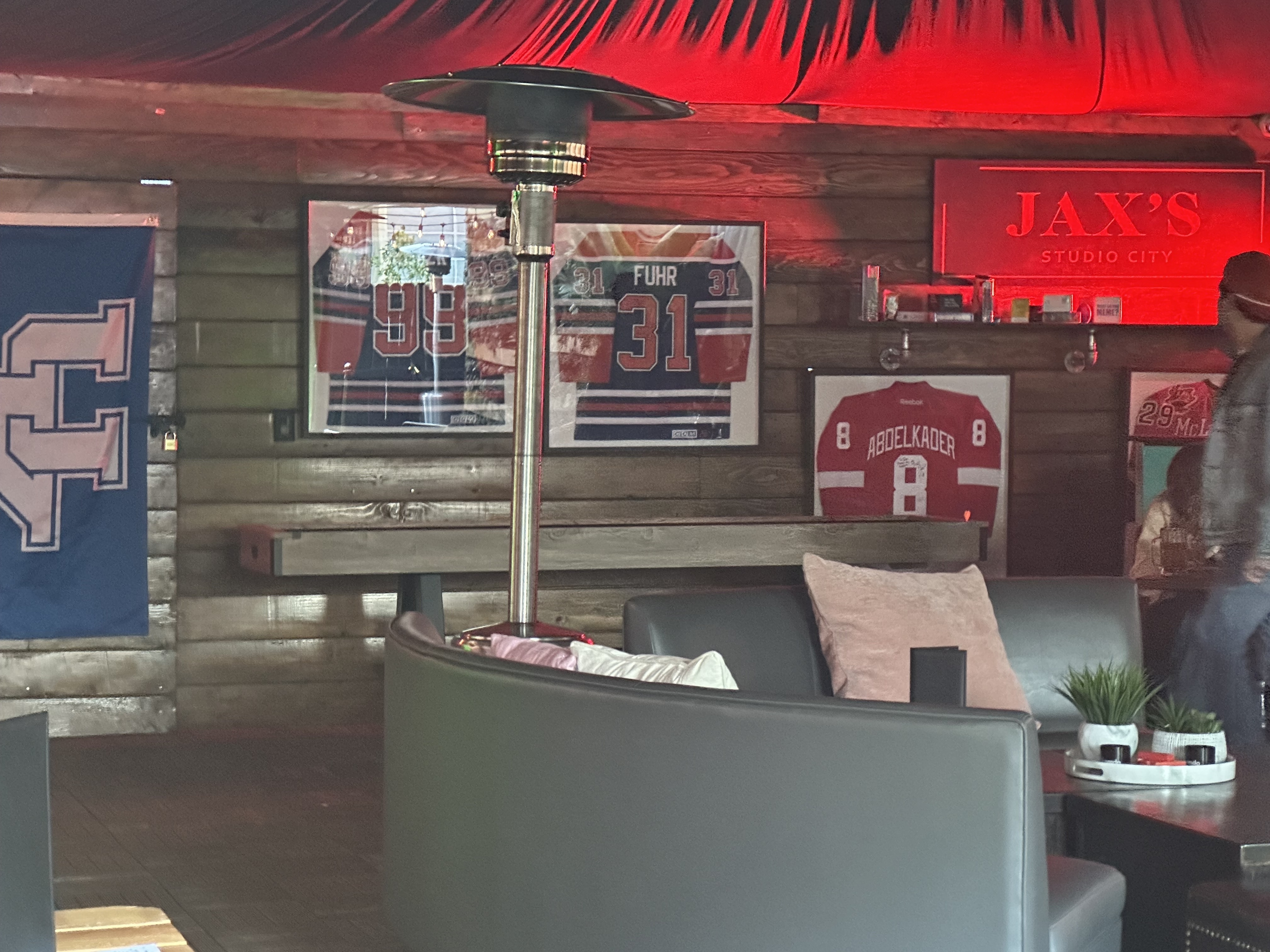 Sports jerseys are displayed on the wall of a casual dining area