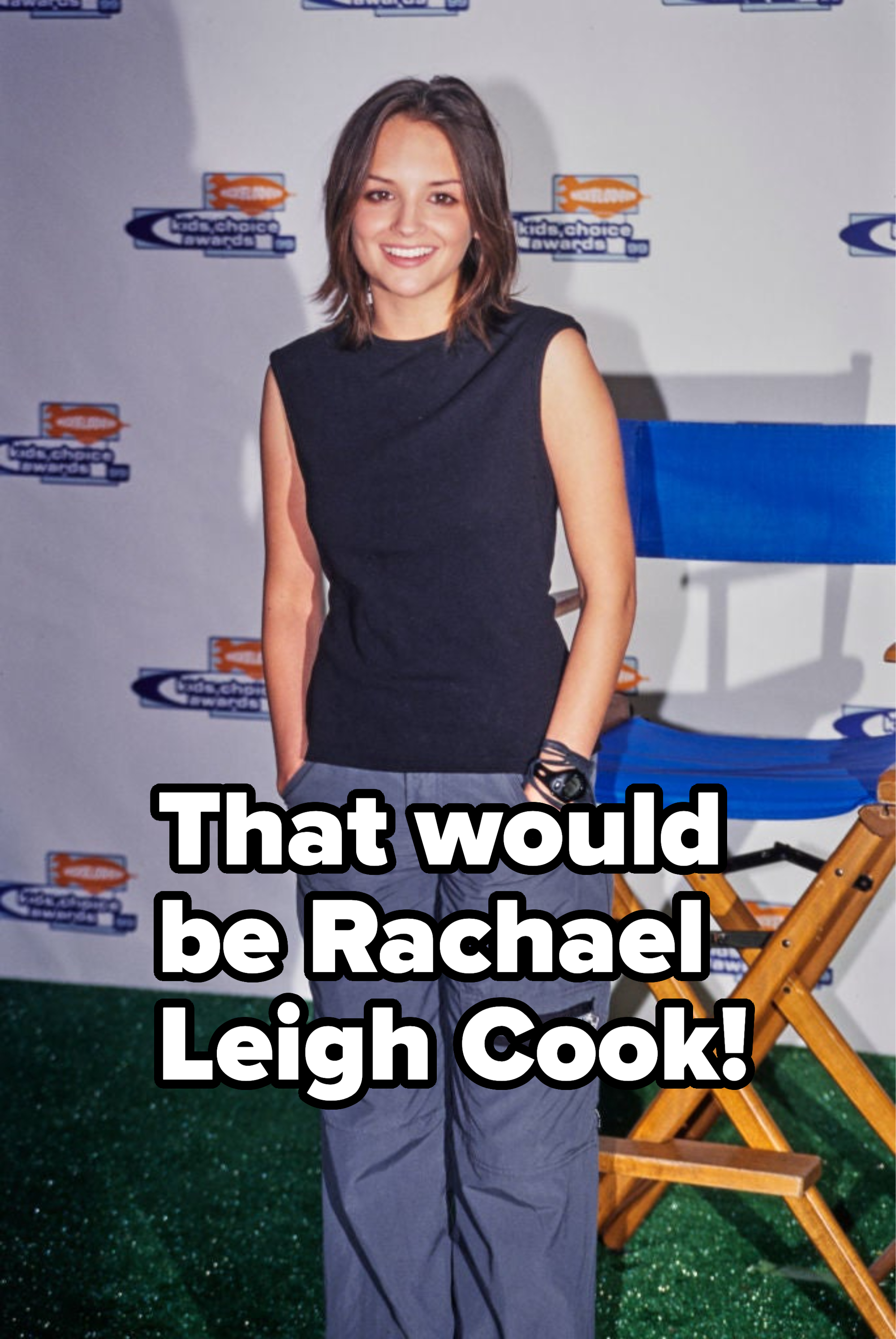 Woman in sleeveless top and cargo pants standing by a director's chair