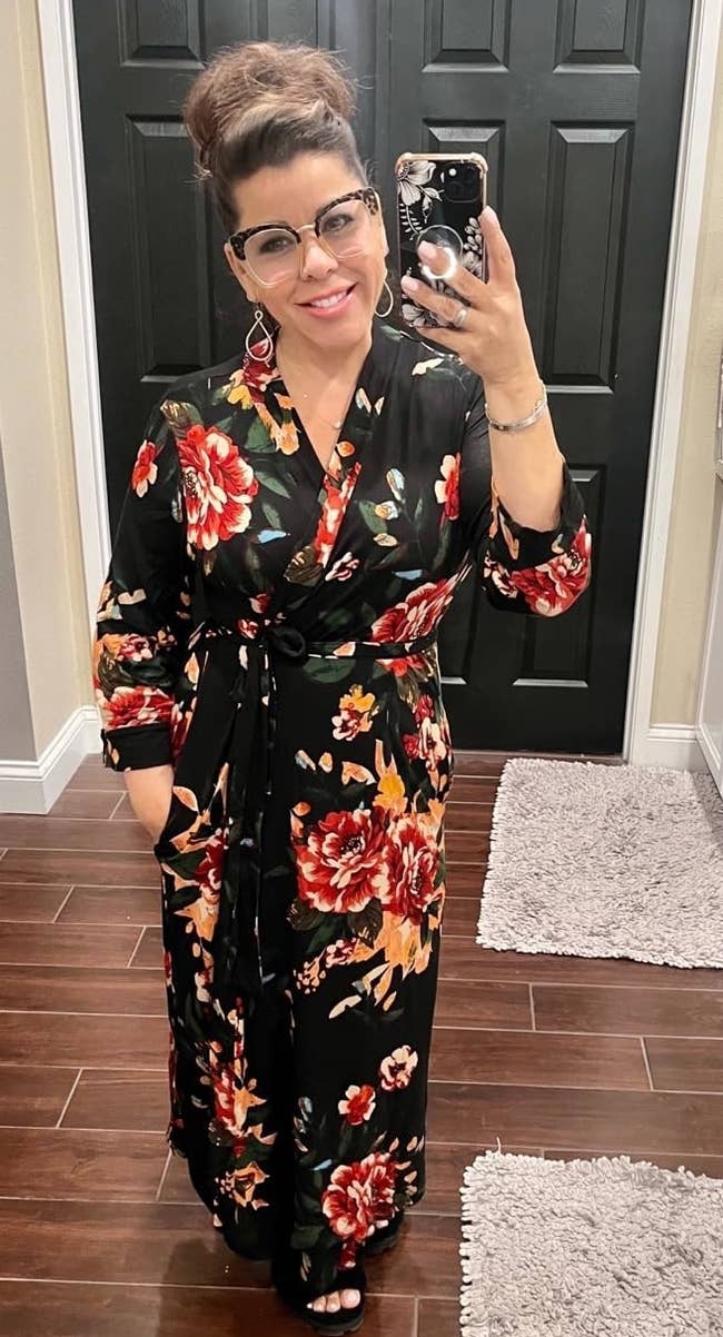 Reviewer's photograph of them wearing a agelong achromatic floral signifier robe, taking a reflector selfie with a phone