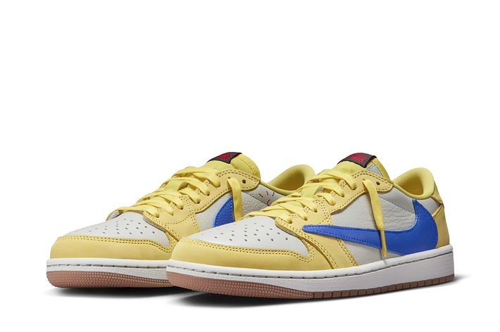 A pair of yellow and blue sneakers with red accents on a white background