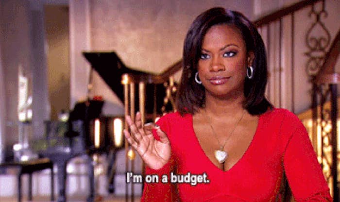 Woman in red top gestures with hand, caption reads &quot;I&#x27;m on a budget.&quot;