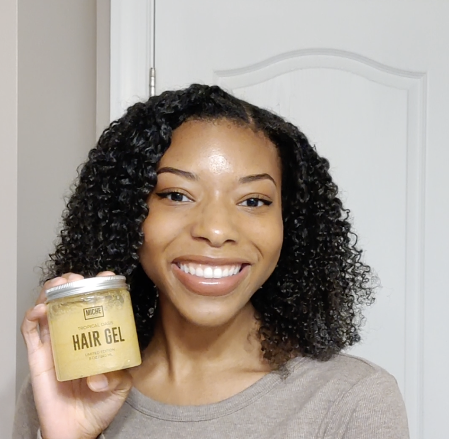Me smiling holding a jar of the hair gel