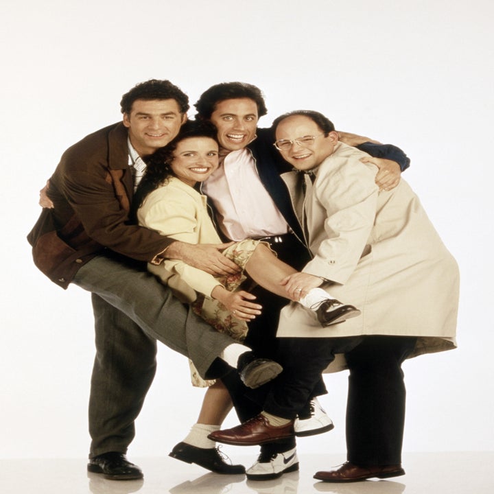 Cast of 'Seinfeld' posing together, with one character playfully held up by the others