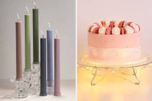 Assorted candles in holders on left; a decorated cake on a stand with lights on right