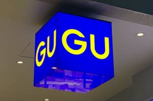 Sign with the text "GUGU" hanging from a ceiling