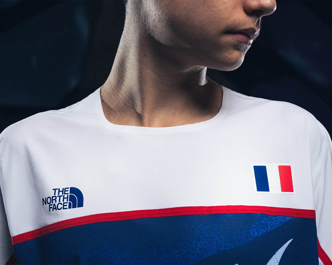 Person wearing sports jersey with The North Face logo and French flag