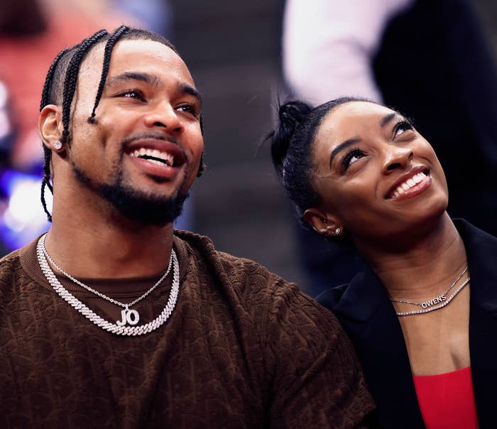 Simone Biles and her husband, Jonathan Owens smiling and looking up