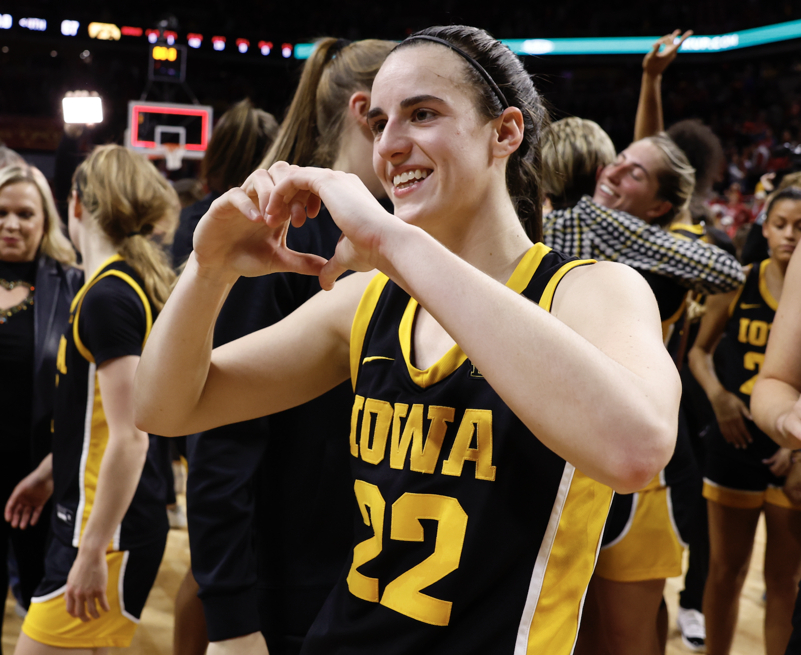 Closeup of Caitlin Clark doing a heart with her hands after a game