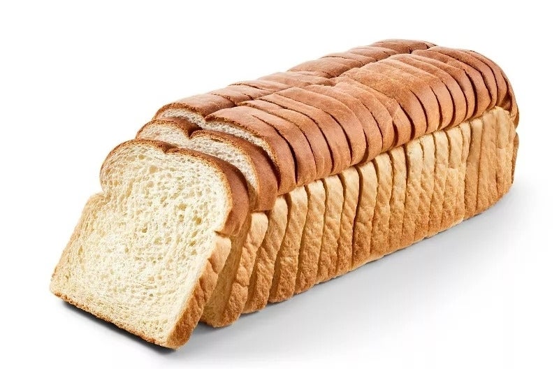 A loaf of sliced white bread on a white background