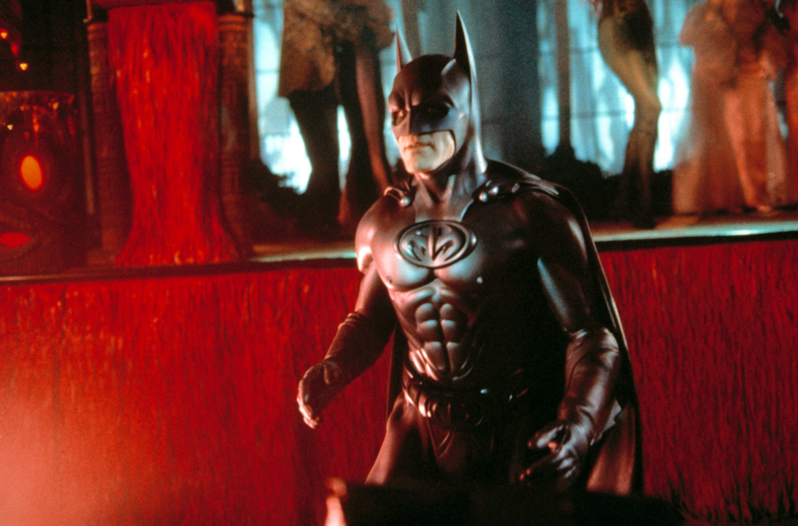 Batman in a sculpted batsuit stands poised for action