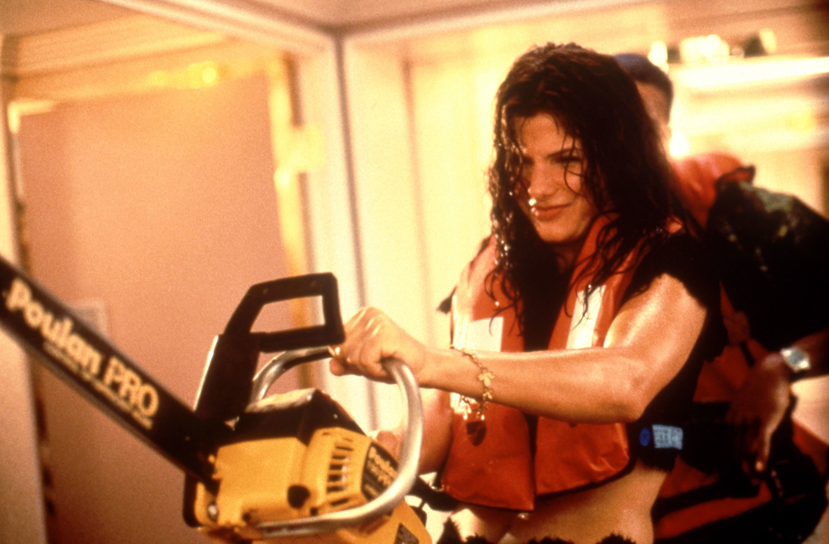 in a scene, Sandra holding a chainsaw, wearing a life jacket