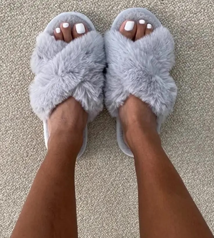 Person wearing fluffy slippers suitable for indoor use
