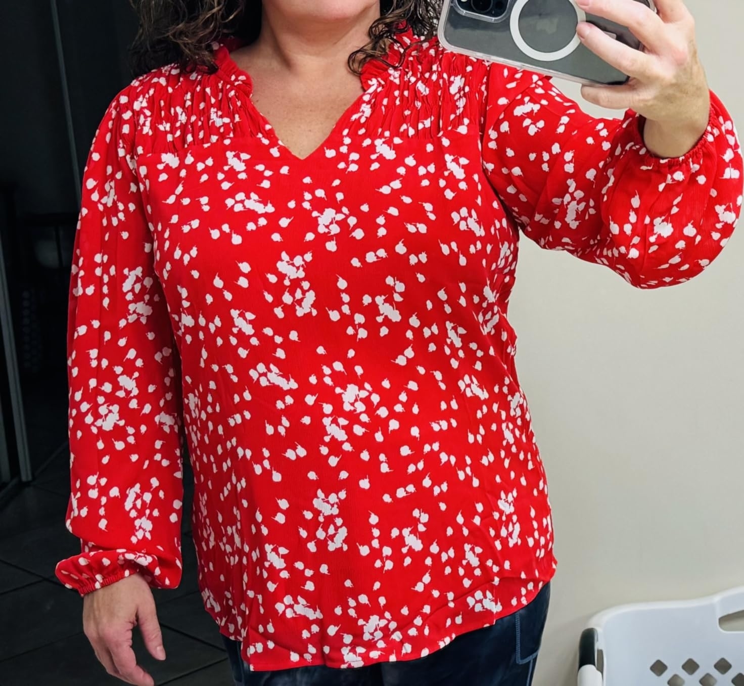 Reviewr taking a selfie wearing the patterned red blouse
