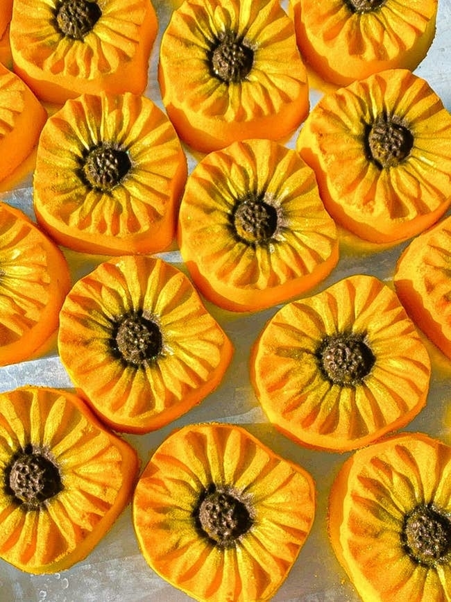 Assorted realistic handmade pumpkin-shaped soaps arranged neatly for display