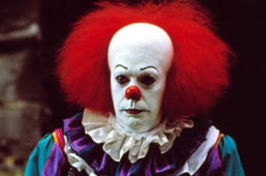 Pennywise the clown from Stephen King's 'It' stands with a menacing expression