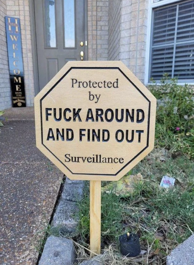 Sign in front of a house reads &quot;Protected by F*** Around and Find Out Surveillance&quot; with humorous intent