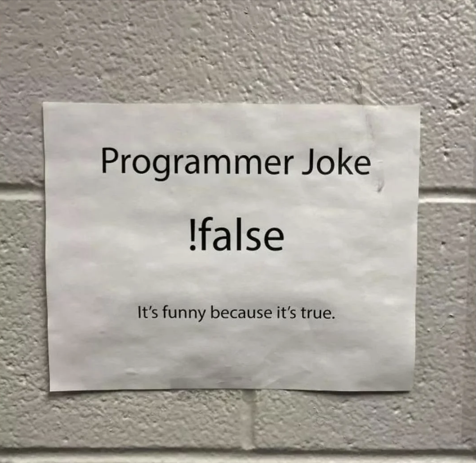 Sign on a wall with a programmer joke that reads &#x27;!:false It&#x27;s funny because it’s true.&#x27;