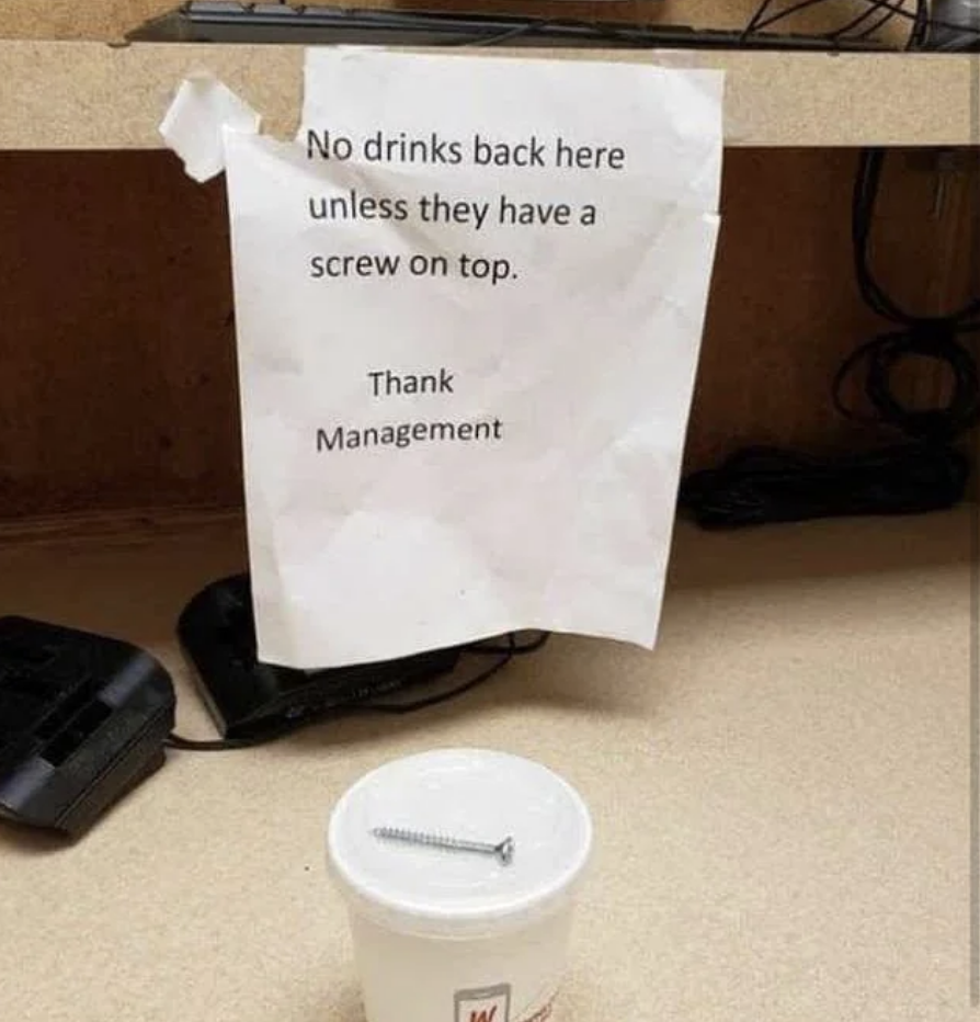 Sign reads &quot;No drinks back here unless they have a screw on top. Thank Management,&quot; with cup and screw illustrating the joke