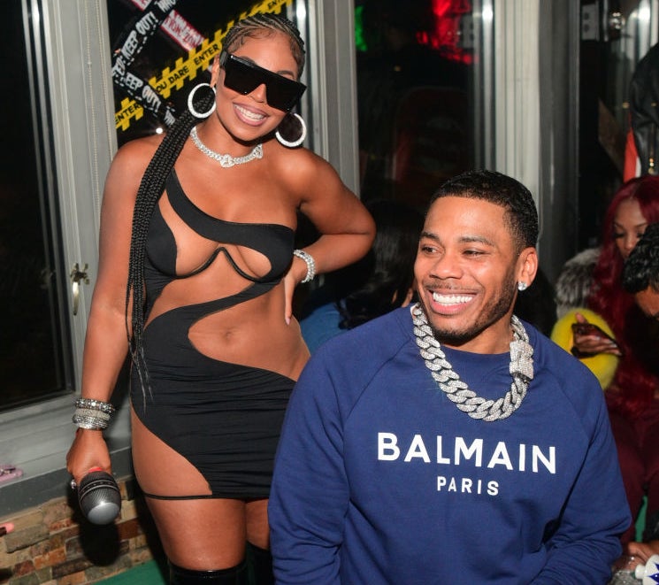 Closeup of Ashanti and Nelly smiling at an event