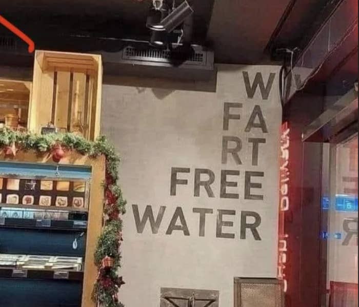 Sign reads &quot;WATER FART FREE,&quot; due to incorrect line break, meant to say &quot;FREE WATER.&quot;